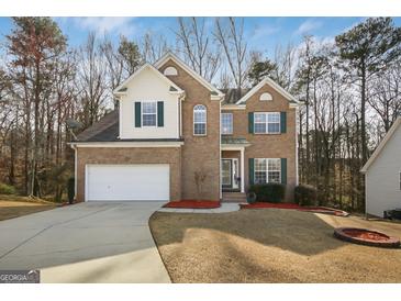Charming two-story home with brick facade, green shutters, and well-maintained lawn at 3867 Summer Kitchen Way, Lilburn, GA 30047