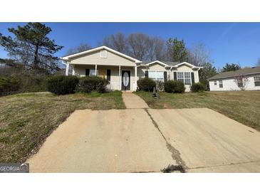 Charming single-story home with a well-manicured front yard and inviting entrance at 133 Dove Lndg, Social Circle, GA 30025