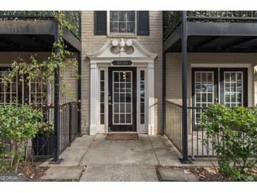 Inviting entrance with black trimmed windows, railings, and door with the building number displayed above it at 3529 Essex Ave # 75, Atlanta, GA 30339