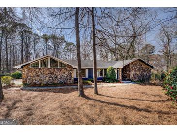 Charming stone-accented home with mature trees and beautiful landscaping in a desirable neighborhood at 825 Sugar Creek Se Way, Conyers, GA 30094