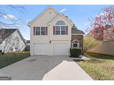 Charming two-story home with a well-manicured lawn and attached two-car garage at 11789 Registry Blvd, Hampton, GA 30228