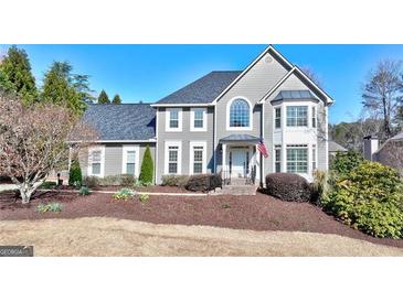 Charming two-story home with well-manicured front yard and inviting entrance at 4569 Chatsworth Ovrlk Ne, Roswell, GA 30075