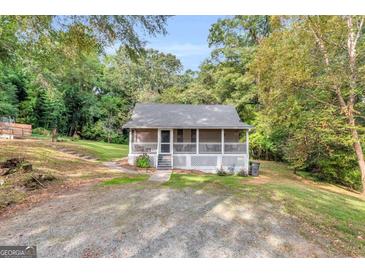Charming single-story home with a inviting screened porch and lush green surroundings at 4481 Mclain Cir, Acworth, GA 30101
