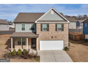 Charming two-story home featuring brick and gray siding, a two-car garage, and a welcoming front porch at 340 Layfield Dr, Jonesboro, GA 30238