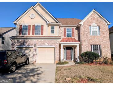 Inviting two-story brick home with a well-manicured lawn and a two-car garage at 5625 Jamerson Dr, South Fulton, GA 30349