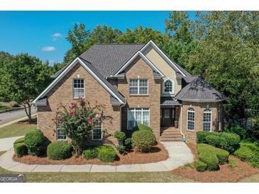 Charming two-story brick home with manicured landscaping and a welcoming front entrance at 1500 Royce Dr, Locust Grove, GA 30248