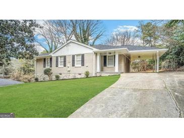 Charming brick home with manicured lawn and convenient carport, perfect for easy access and curb appeal at 2191 Tilson Cir, Decatur, GA 30032