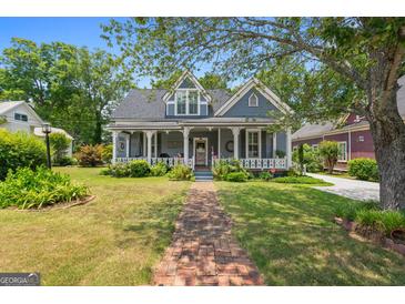 Charming two-story home with a welcoming front porch and meticulously maintained landscaping at 35 W Main St, Hampton, GA 30228