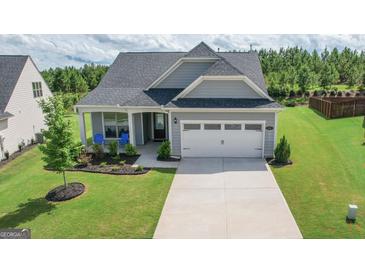 Charming single-Gathering home with a well-manicured lawn and attached two-car garage at 104 Conway St, Peachtree City, GA 30269