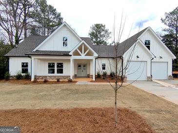Charming new construction home with white siding, gray roof, and a manicured front yard at 6149 Se Pinewood Dr, Covington, GA 30014