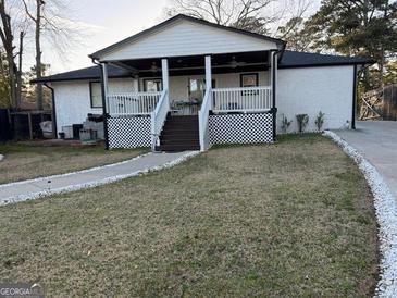 Charming single-story home featuring a covered front porch and well-maintained lawn at 4100 Scott S Dr # 0, Forest Park, GA 30297