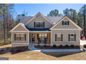 Charming craftsman-style home featuring a covered front porch with rocking chairs and a landscaped front yard at 624 Bexley Rd, Moreland, GA 30259