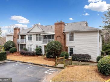 Charming townhouse featuring a brick chimney, exterior balcony, and designated parking at 1379 Keys Lake Ne Dr, Brookhaven, GA 30319