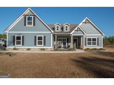 Charming single-Gathering home with blue siding, black shutters, and inviting front porch at 296 Beavers Rd, Grantville, GA 30220