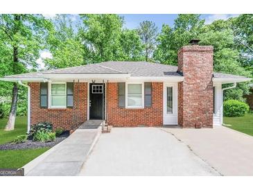 Charming brick home featuring gray shutters and a chimney at 9184 Thrash Sw St, Covington, GA 30014