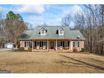 Charming brick home featuring a welcoming front porch and a well-maintained front yard at 1191 Rawlings Dr, Rutledge, GA 30663