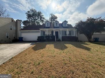 Charming one-story home featuring dormer windows, covered entry porch, and a two-car garage at 2260 Burdett Ridge Dr, South Fulton, GA 30349