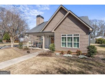 Charming home featuring a shingle facade, covered porch, and well-manicured lawn at 101 Dean Cir, Mcdonough, GA 30253