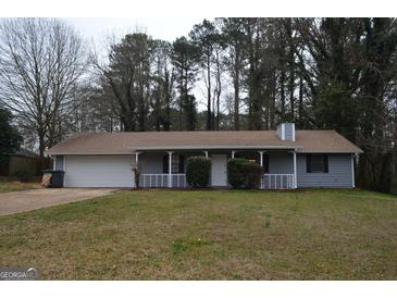 Charming single story home with a cozy front porch and attached two car garage at 4142 Campbell Rd, Snellville, GA 30039