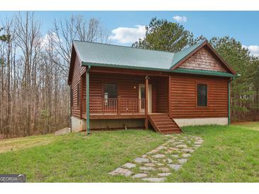 Charming log cabin featuring a quaint front porch and a stone pathway leading to the entrance at 1266 Martin Mill Rd, Moreland, GA 30259