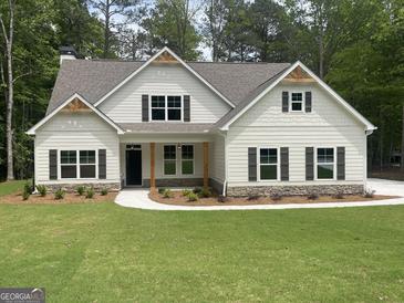 Charming two-story home with white siding, dark shutters, and manicured front lawn at 240 Jay Trl, Fayetteville, GA 30215