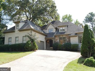 Charming two-story home featuring stone accents, a well-manicured lawn, and an inviting driveway at 3860 Bays Ferry Trl, Marietta, GA 30062