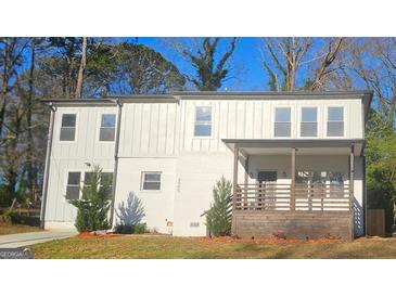 Charming two-story home featuring a covered front porch and a freshly painted exterior at 2085 Dellwood Pl, Decatur, GA 30032