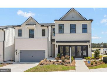 A bright, modern two-story townhouse features a two-car garage and striking curb appeal at 982 Sutherland Ln # 30, Lawrenceville, GA 30043