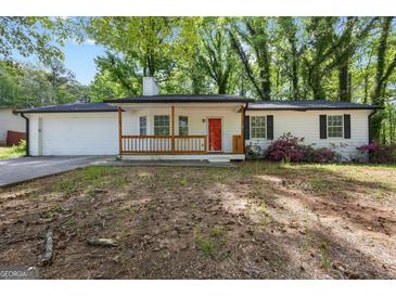 Charming single-story home featuring a quaint front porch and a vibrant red front door at 1620 Summit Rdg, Auburn, GA 30011