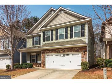Charming two-story home with a stone-accented facade, two-car garage, and well-maintained landscaping at 903 Hollytree Pl, Acworth, GA 30102