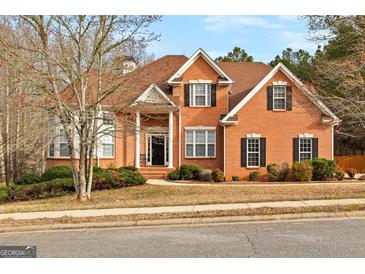 Charming brick home featuring a landscaped front yard, black shutters, and a classic architectural design at 510 Virginia Highlands, Fayetteville, GA 30215