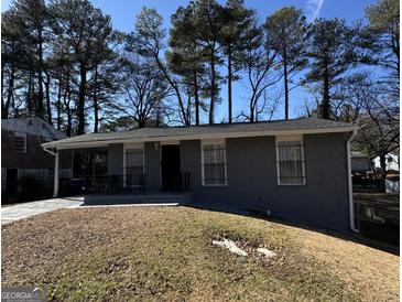 Charming brick home featuring a well-maintained front yard and a welcoming entrance at 452 Fedora Nw Way, Atlanta, GA 30331