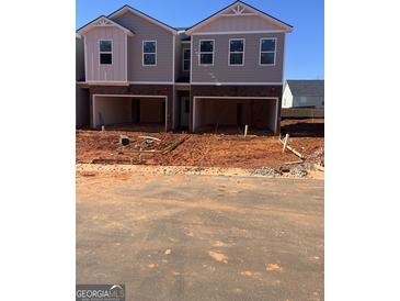 New townhome construction featuring gray siding and a drive-under garage at 11551 Kimberly Way # 17, Hampton, GA 30228