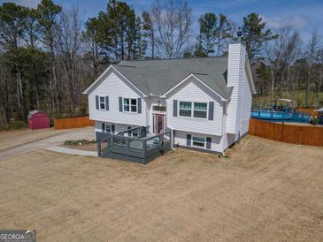 Charming two-story home with a spacious front yard and inviting deck at 31 Pecan Lake Ct, Sharpsburg, GA 30277