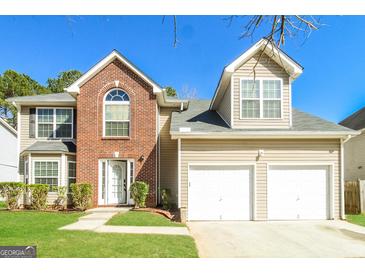Charming two-story home featuring a brick accent, a two-car garage, and a well-maintained front yard at 5345 Bridle Point Pkwy, Snellville, GA 30039