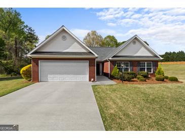 Charming brick home with a well-manicured lawn, two-car garage, and inviting curb appeal at 628 Morningside Dr, Stockbridge, GA 30281