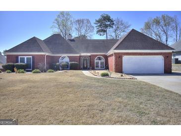 Charming single-story brick home with an attached two-car garage and a well-manicured lawn at 2808 Autumn Lake Ln # D/6, Decatur, GA 30034