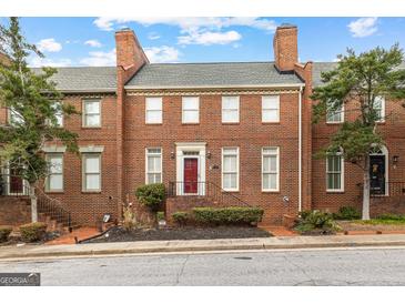 Charming brick townhouse with a red front door and classic architectural details at 180 Habersham Pl, Fayetteville, GA 30214