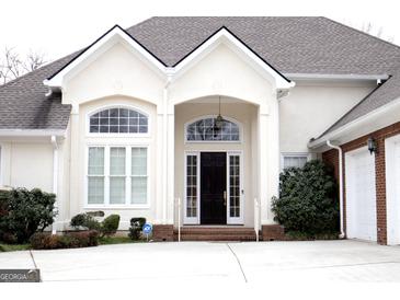 Inviting front entrance featuring an arched doorway and decorative windows in a bright and well maintained home at 5188 Ashley Se Dr, Covington, GA 30014