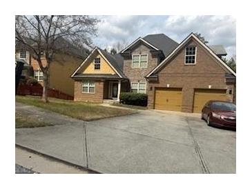 Charming brick two-story home featuring a two-car garage and well-maintained front yard at 4371 Minkslide Sw Dr, South Fulton, GA 30331