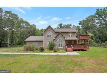 Charming two-story home boasts a stone facade and a spacious deck, blending rustic charm with modern living at 133 Harold Dr, Mcdonough, GA 30253