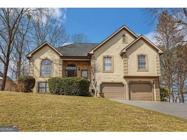 Charming two-story home with a well-manicured lawn and a two-car garage at 3435 Pierce Arrow Cir, Suwanee, GA 30024