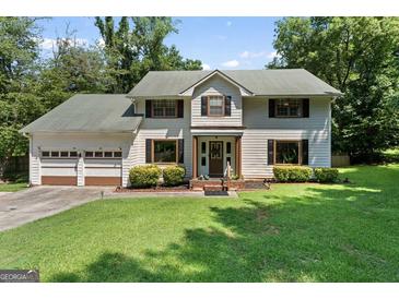 Charming two-story home with a well-manicured lawn and a two-car garage, perfect for families at 2612 New Haven Dr, Jonesboro, GA 30236