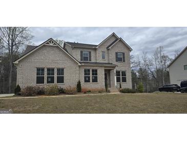 Beautiful two-story brick home with professionally landscaped yard and manicured lawn at 336 Traditions Ln # 147, Hampton, GA 30228