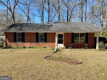 Charming single-story brick home with a well-maintained lawn and a classic, welcoming exterior at 924 Polk Rd, Moreland, GA 30259