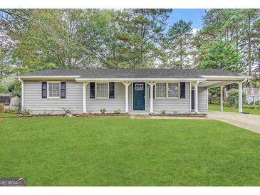 Charming single-story home with a well-maintained lawn and inviting carport at 2987 Landmark Se Dr, Conyers, GA 30094