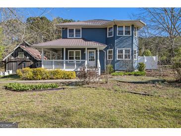 Charming two-story home with a welcoming front porch and a well-maintained, traditional style in a beautiful country setting at 650 Moseley Rd, Stockbridge, GA 30281