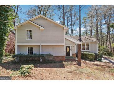Charming two-story home features a well-maintained yard and inviting front entrance at 4967 Post Road Pass, Stone Mountain, GA 30088