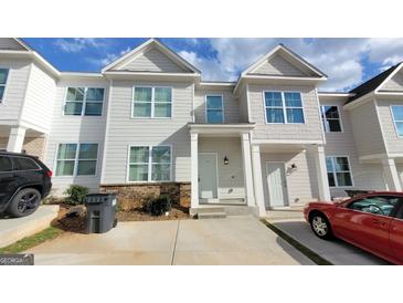 Inviting townhouse featuring a well-manicured lawn and convenient parking at 2780 Laurel Ridge Cir, East Point, GA 30344