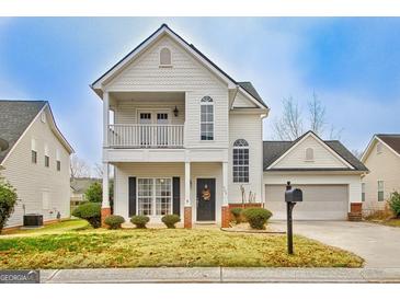 Charming two-story home featuring a welcoming front porch and attached two-car garage at 306 Turtle Pointe Dr, Carrollton, GA 30116
